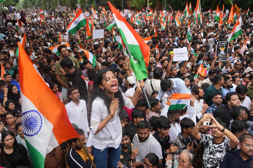 Protesters celebrate after Education Minister Dharmendra Pradhan resigned following nationwide protests as part of the Cockroach Janta Party's protest movement in Mumbai, India, Sunday, 26 July 2026 (AP)