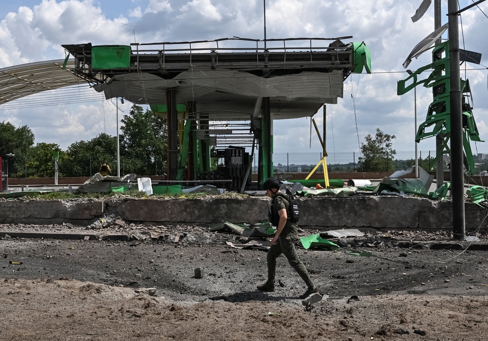 A prosecutor's office employee walks at the site of a petrol station hit by a Russian airstrike, amid Russia's attack on Ukraine, in Zaporizhzhia, Ukraine July 26, 2026. (Reuters)