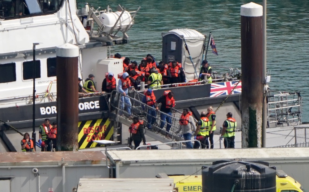 A group of people thought to be migrants are brought in to the Border Security Command compound in Dover, Kent, on Thursday (Gareth Fuller/PA) (PA Wire)