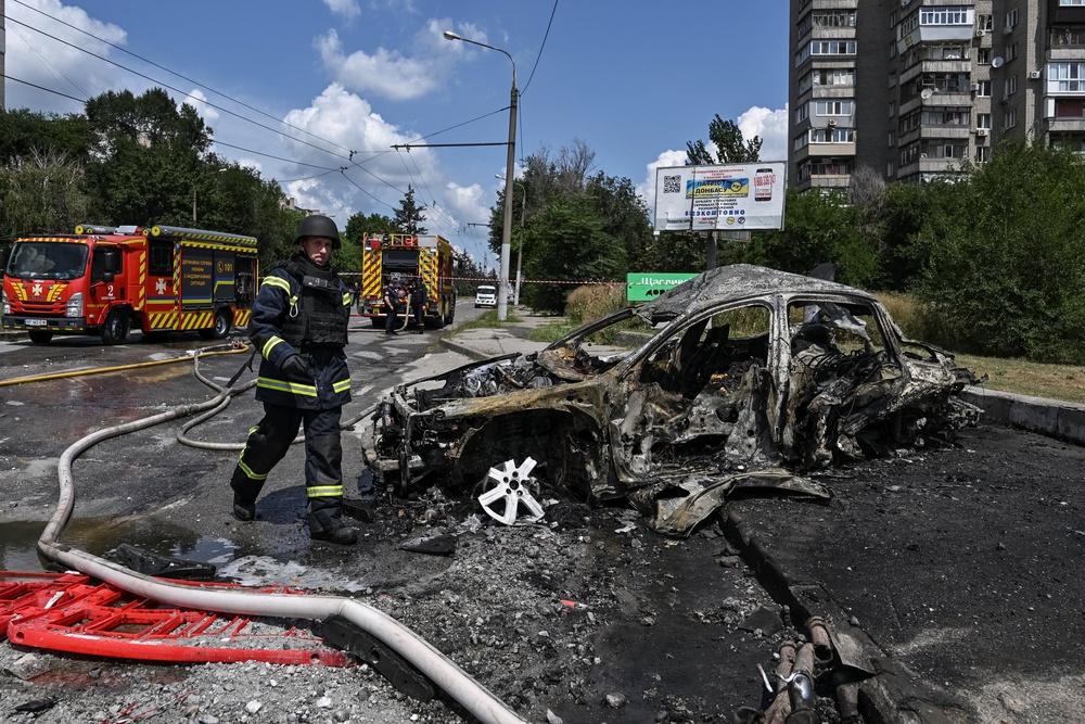 A firefighter walks at the site of a petrol station hit by a Russian airstrike, amid Russia's attack on Ukraine, in Zaporizhzhia (Reuters)