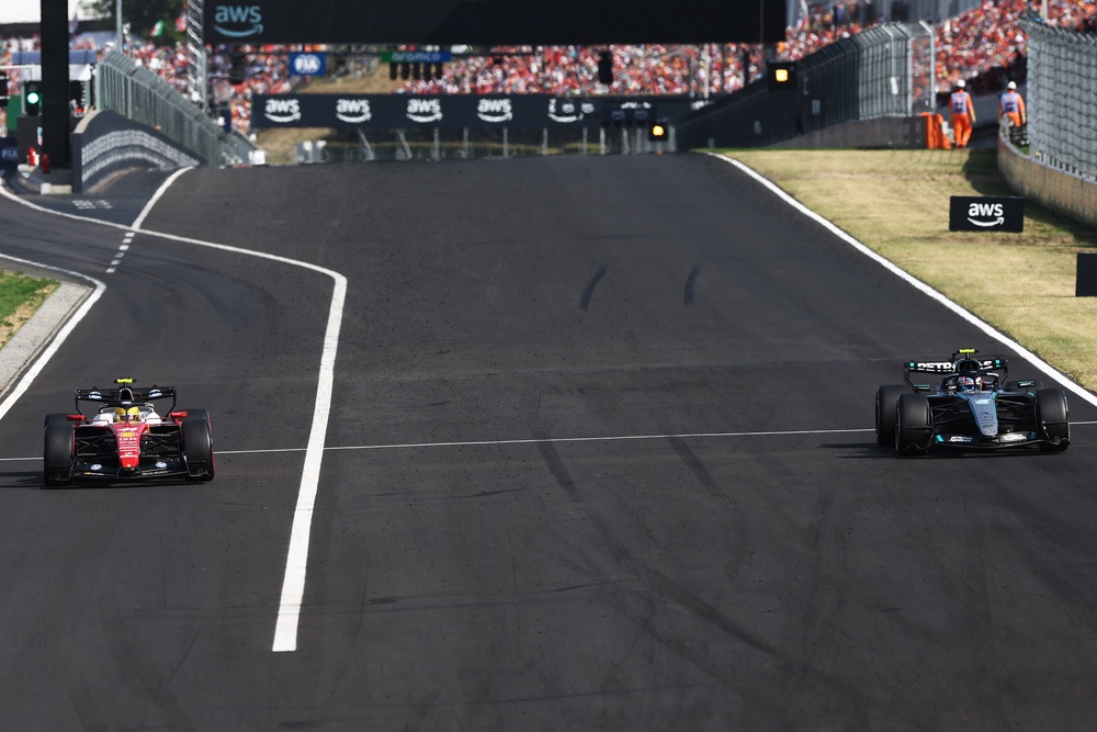 Lewis Hamilton (left) was penalised for speeding in the pit lane (Getty)