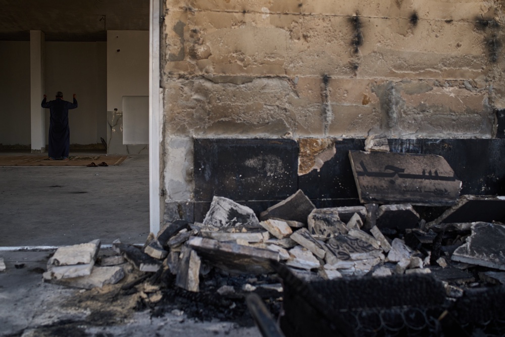 A Palestinian man prays inside a mosque that was burned during an attack by Israeli settlers early in the morning in the West Bank village of Qusra, Sunday, July 26, 2026. (AP Photo/Leo Correa) (Copyright 2026 The Associated Press. All rights reserved.)