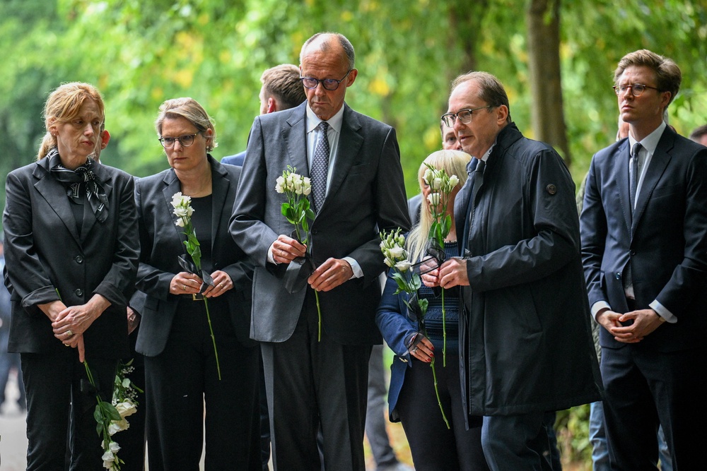German chancellor Friedrich Merz and interior minister Alexander Dobrindt pay their respects at Tiergarten park (Reuters)