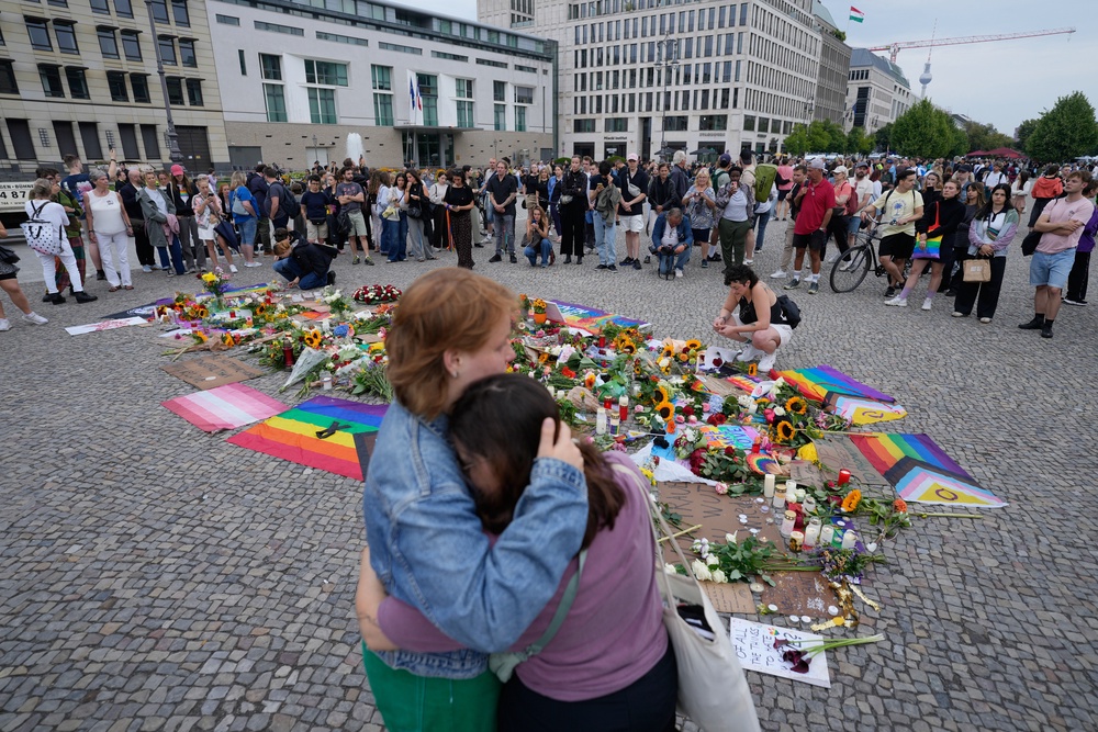Devastated crowds gather at the Brandenburg Gate in Berlin for a demonstration in support of the LGBTQ+ community (AP)