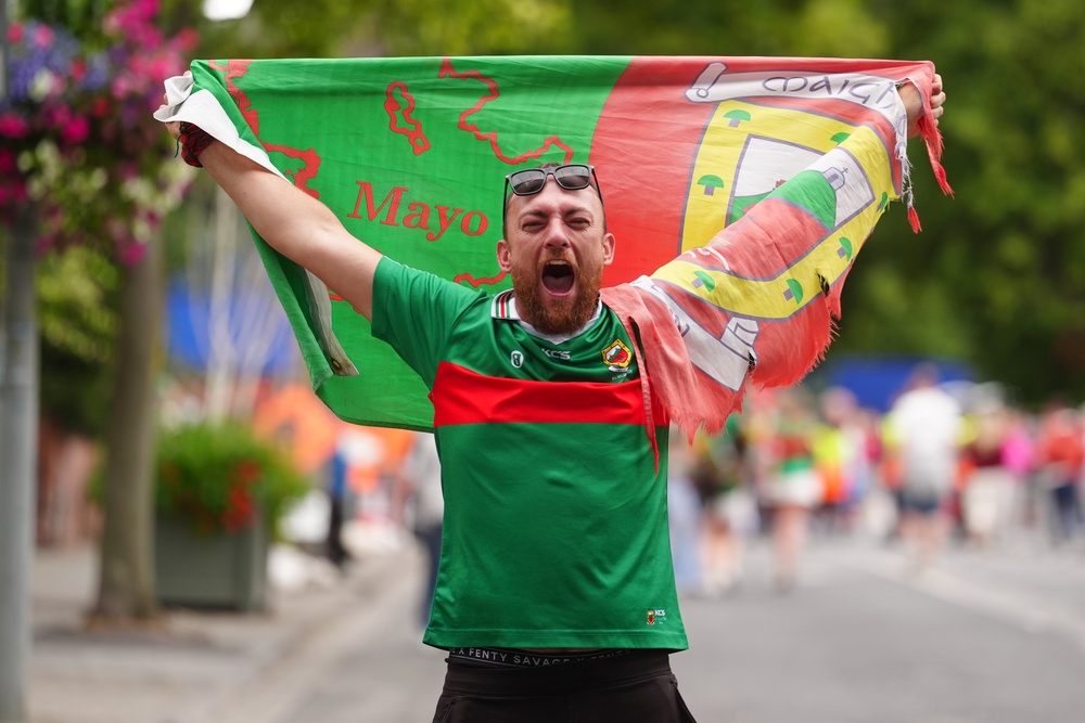 Mayo supporters celebrate outside Croke Park stadium after Mayo beat Kerry in the All-Ireland Senior Football Championship final, the team's first win since 1951 (PA)
