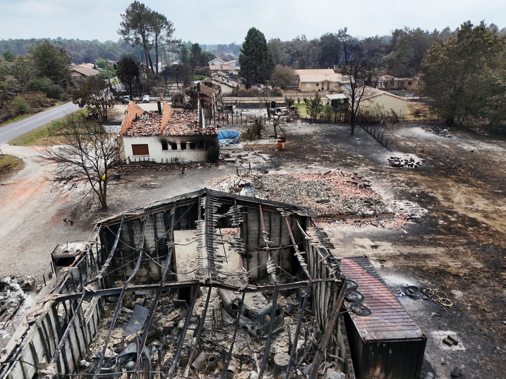 A drone view shows a burnt building in an area affected by wildfire, in Le Porge, Gironde, amongst worsening drought conditions following a heatwave and water shortages across much of France (Reuters)