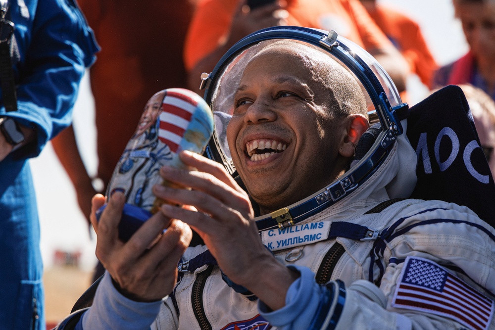 Nasa astronaut Christopher Williams receives a Russian traditional wooden doll Matryoshka as he rests after returning from the International Space Station (ISS) aboard the Soyuz MS-28 space capsule (Reuters)