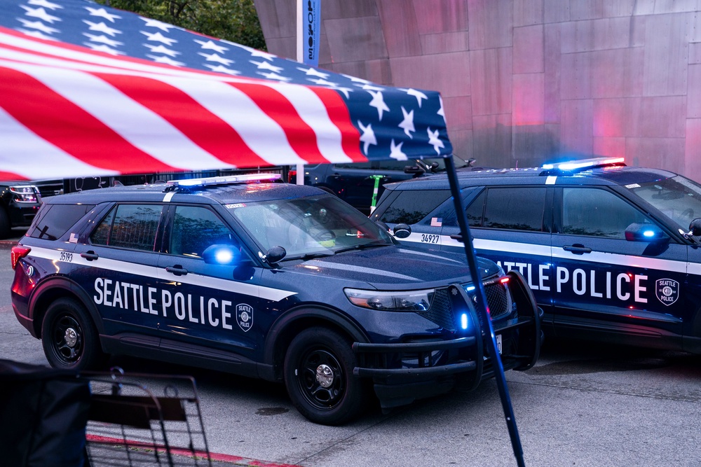 Police vehicles are parked next to a vendor tent following a mass shooting at the Bite of Seattle food festival on 26 July 2026 in Seattle, Washington (Getty)