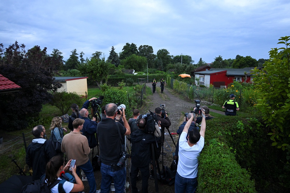 Police secure the area at an allotment garden complex in the Berlin suburb of Spandau, after a known Islamist, suspected of ramming a minivan into a crowd near Berlin's annual Christopher Street Day Pride parade on Saturday evening, was shot and killed in a police operation (Reuters)
