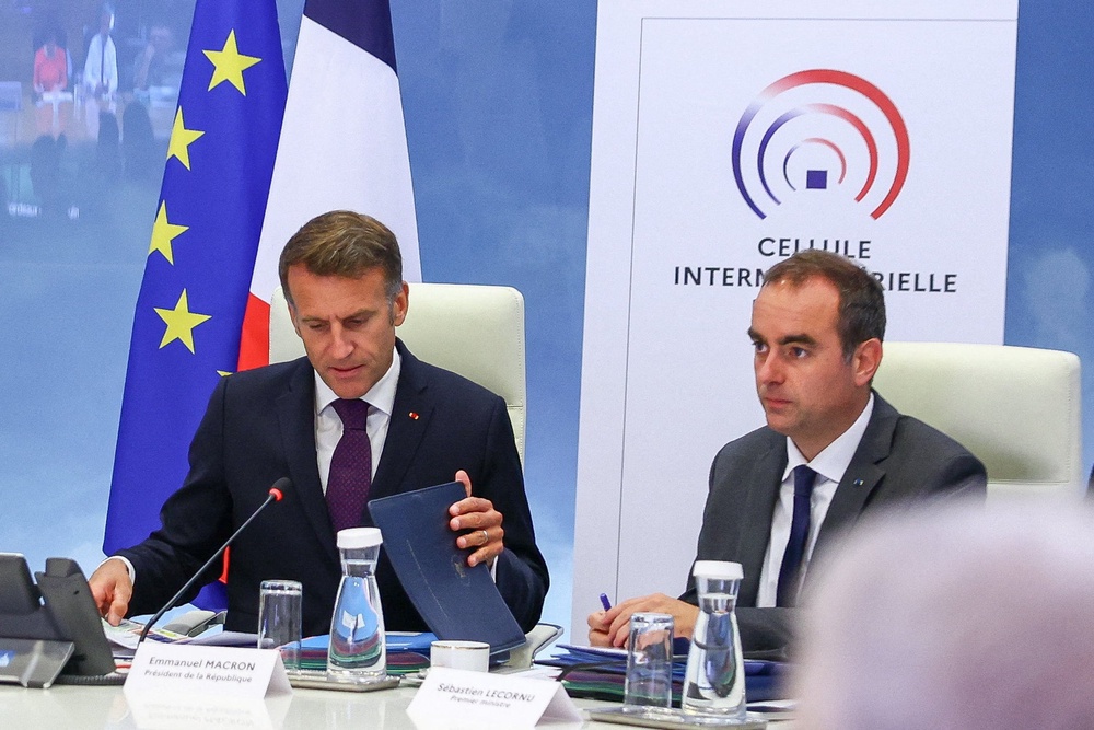 France's President Emmanuel Macron (L) and France's Prime Minister Sebastien Lecornu (R) attend a meeting with members of the cabinet to discuss wildfires in the country, at the Hotel de Beauvau, the French Interior Ministry, in Paris on July 27, 2026. (AFP/Getty)