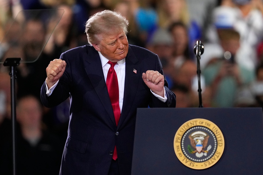 President Donald Trump dances after speaking at an event at the General Motors Proving Ground Monday, (AP)