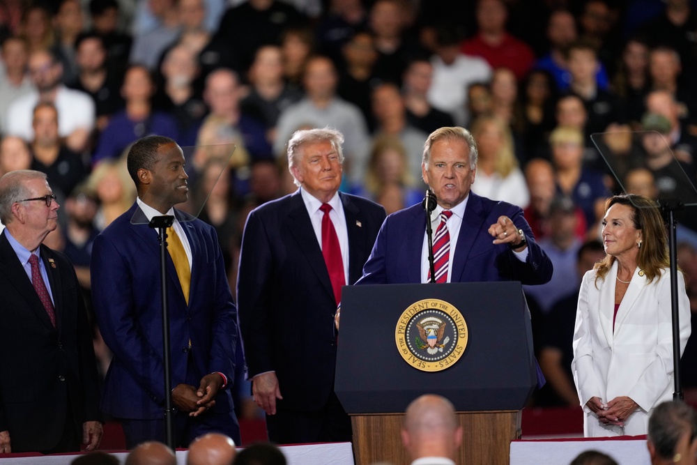 Republican Senate candidate Mike Rogers speaks as Rep. Tim Walberg, R-Mich., Rep. John James, R-Mich., President Donald Trump and Rep. Lisa McClain, R-Mich., listen at an event at the General Motors Proving Ground Monday (AP)