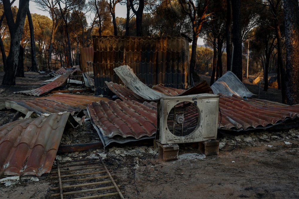 Camping La Ardilla Roja is burnt out next to Pantano de San Juan following wildfires (Getty)