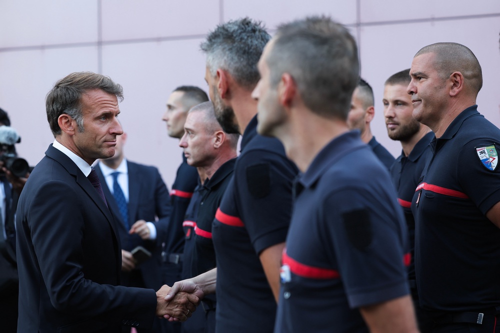 Emmanuel Macron, left, visits the departmental fire and rescue operational center (CODIS) in Bordeaux, France (AP)
