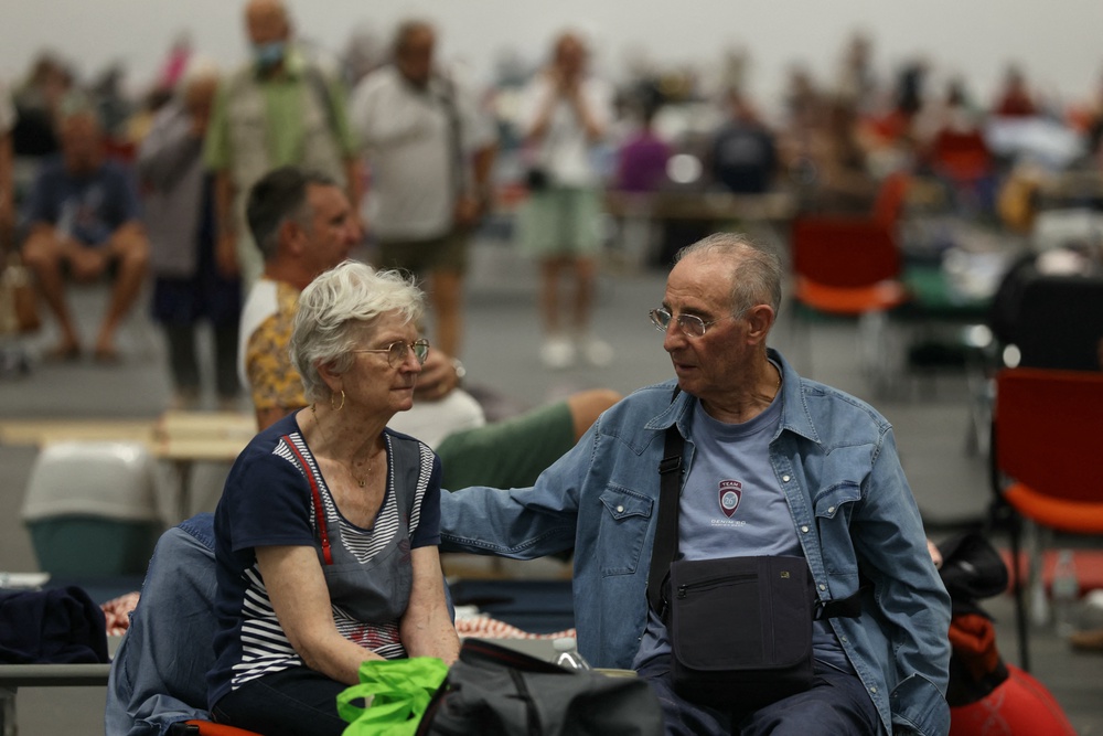 A couple evacuated due to the wildfires shelter at the Parc des Expositions de Bordeaux in Bordeaux, on July 25, 2026. (AFP/Getty)