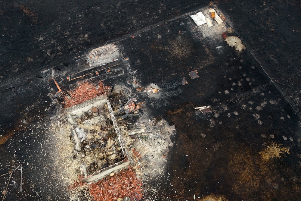 A drone view shows a burnt building in an area affected by a wildfire, in Le Porge, Gironde, during drought conditions, 27 July 2026 (Reuters)