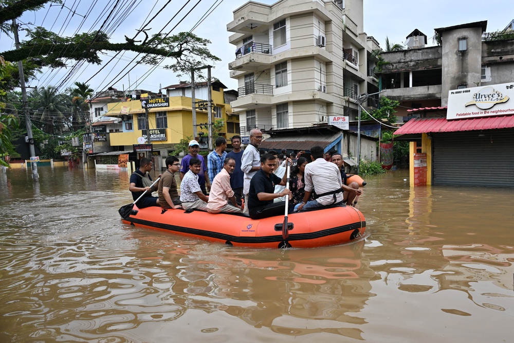State Disaster Response Fund (SDRF) personnel rescue residents from a flooded area after heavy rainfall in Guwahati (AFP/Getty)