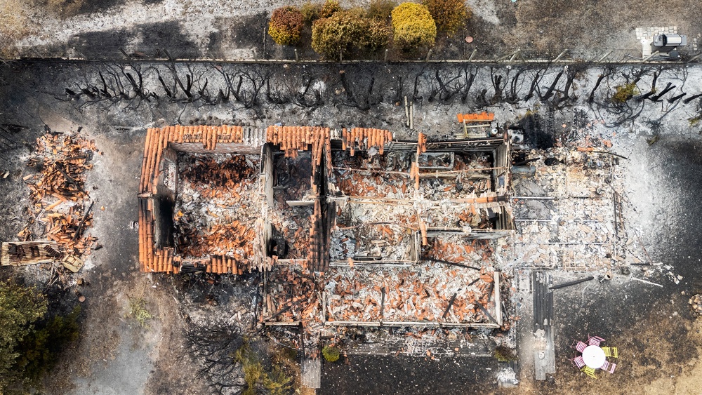 A burnt-out building after a wildfire in Le Porge, in the Gironde Department, southwestern France, on 25 July (AFP/Getty)