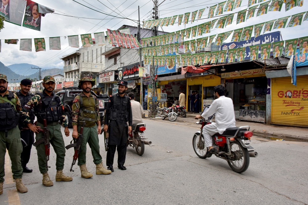 Pakistan Frontier Constabulary personnel stand guard along a street in Muzaffarabad, the capital of Pakistan-administered Kashmir on 26 July 2026 on the eve of the first phase of the regional elections (AFP/Getty)