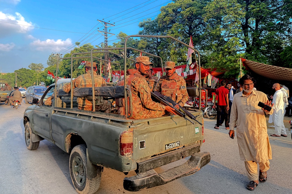 Army personnel patrol outside a polling station in Mirpur, Pakistan-administered Kashmir, on 27 July 2026 (AFP/Getty)