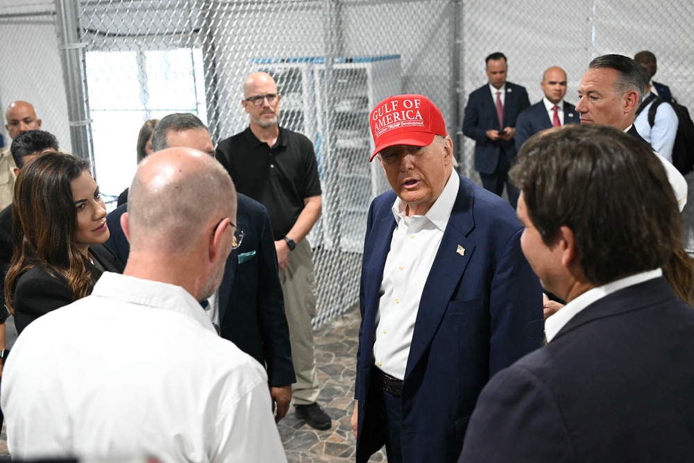 Trump (centre), Florida Governor Ron DeSantis (right), and secretary of Homeland Security Kristi Noem (not pictured) tour a migrant detention centre, dubbed ‘Alligator Alcatraz’ (AFP/Getty)