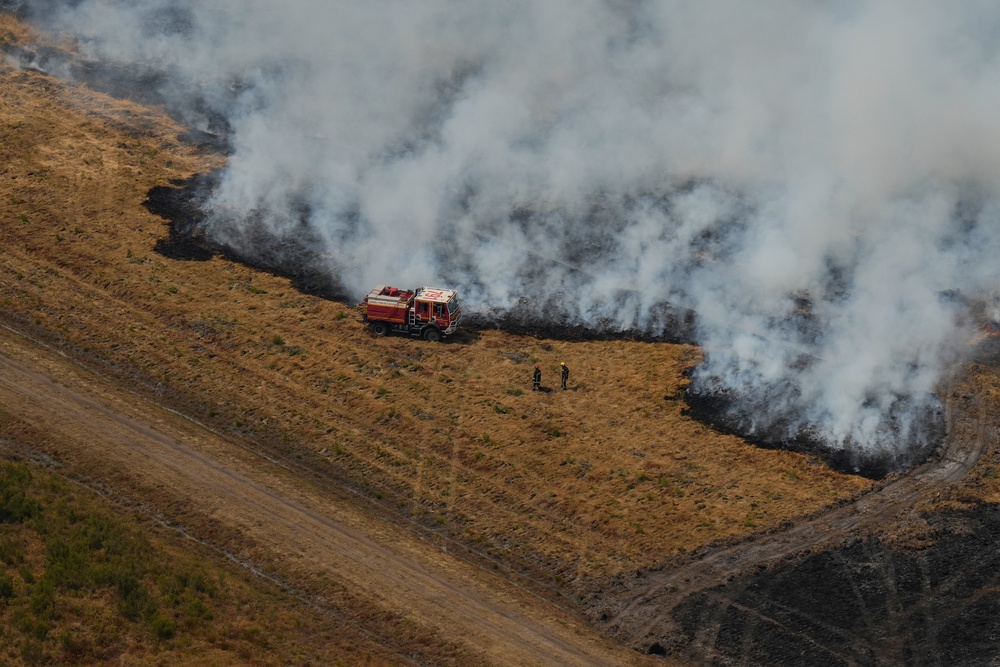 Firefighters try to suppress a fire burning through a field near Ares, southwestern France (AFP/Getty)