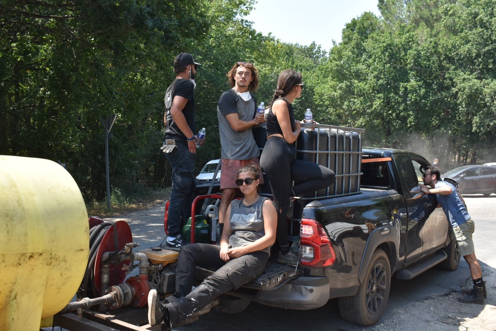 A pick-up truck with water and volunteers ready to circle the forests and scout for break-out fires (James Reynolds/The Independent)