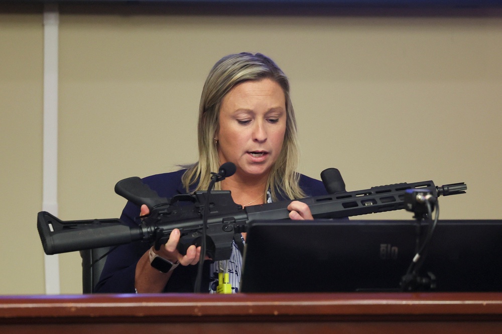 An investigator with the Barrow County District Attorney's office looks over the assault rifle that Colt Gray used in the Apalachee High School shooting (Jason Getz/Atlanta Journal-Const)