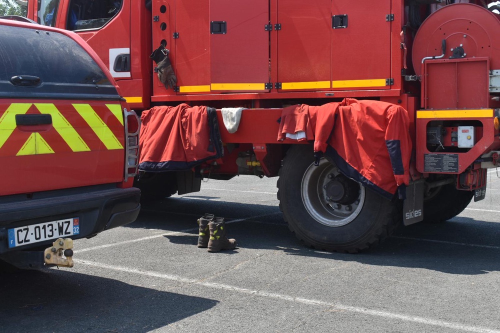 Firefighters stop to rest and eat at the centre offering food in town (James Reynolds/The Independent)