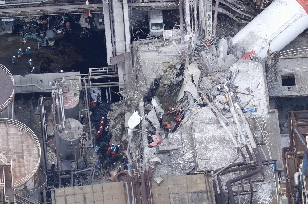 A drone view shows rescue workers at Nippon Paper Industries factory after an earthquake (Reuters)