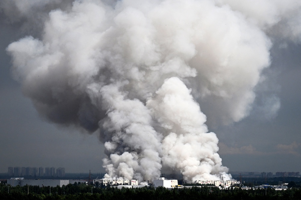 Smoke rises from a warehouse for a Russian e-commerce giant near Saint Petersburg after being hit by Ukrainian drones early on 24 July 2026 (AFP/Getty)