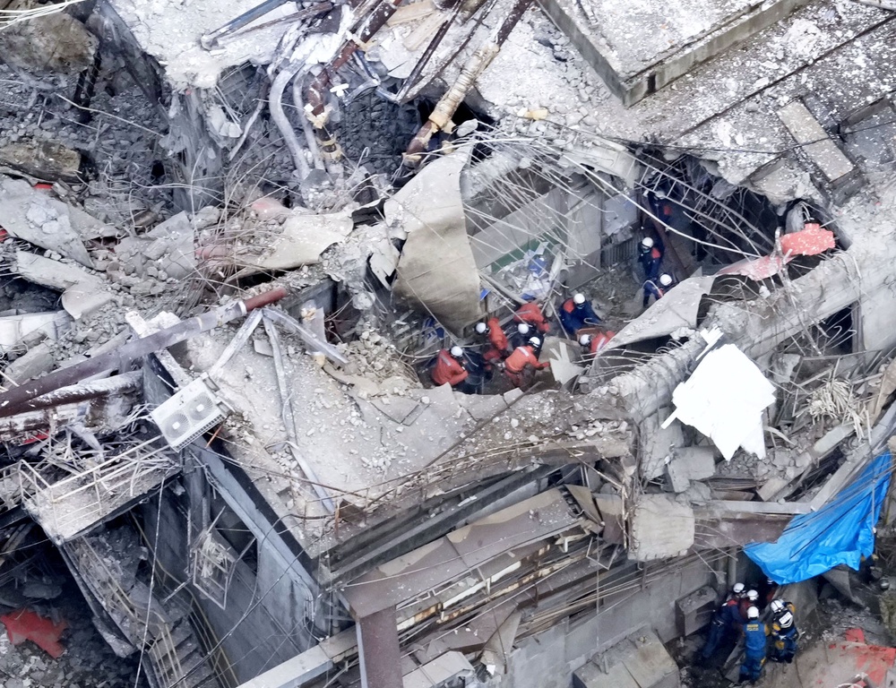 An aerial view shows rescue workers at Nippon Paper Industries factory (Reuters)