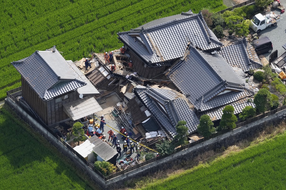 This aerial image shows rescuers working at the house collapsed by an earthquake (AP)