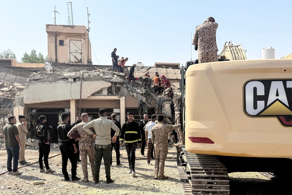 Security forces and emergency personnel work at the site of a strike north of al-Miqdadiyah district in Iraq's Dayala province on July 29 (AFP/Getty)