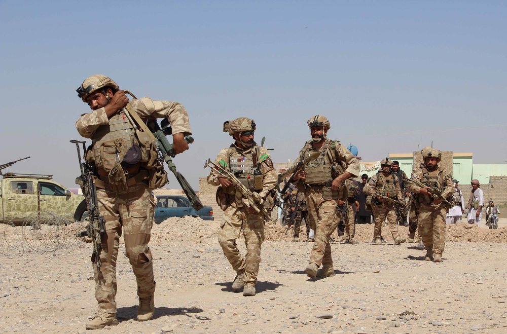 Afghan National Army commandos take position during a military operation in Helmand province in 2016 (AFP via Getty Images)