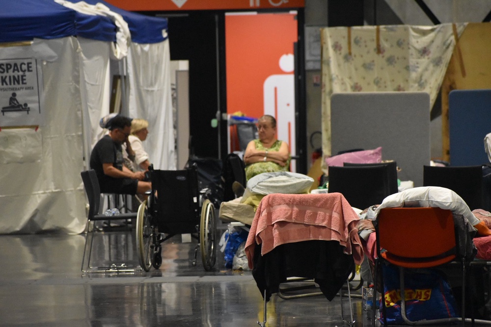 A large hall in Bordeaux has become a temporary home to hundreds displaced by the ongoing wildfires (James Reynolds / The Independent)