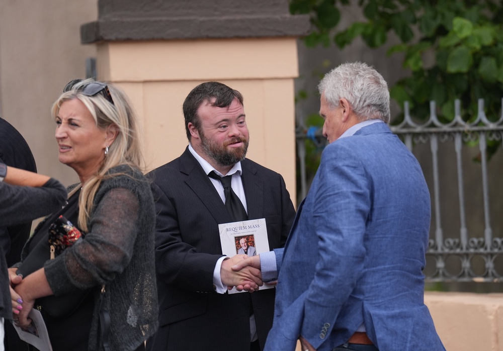 From left, Lynda Bryans, James Martin and journalist Chris Moore leave after the funeral of Gerry Kelly at St Nicholas Church in Ardglass, Co Down (Niall Carson/PA) (PA Wire)