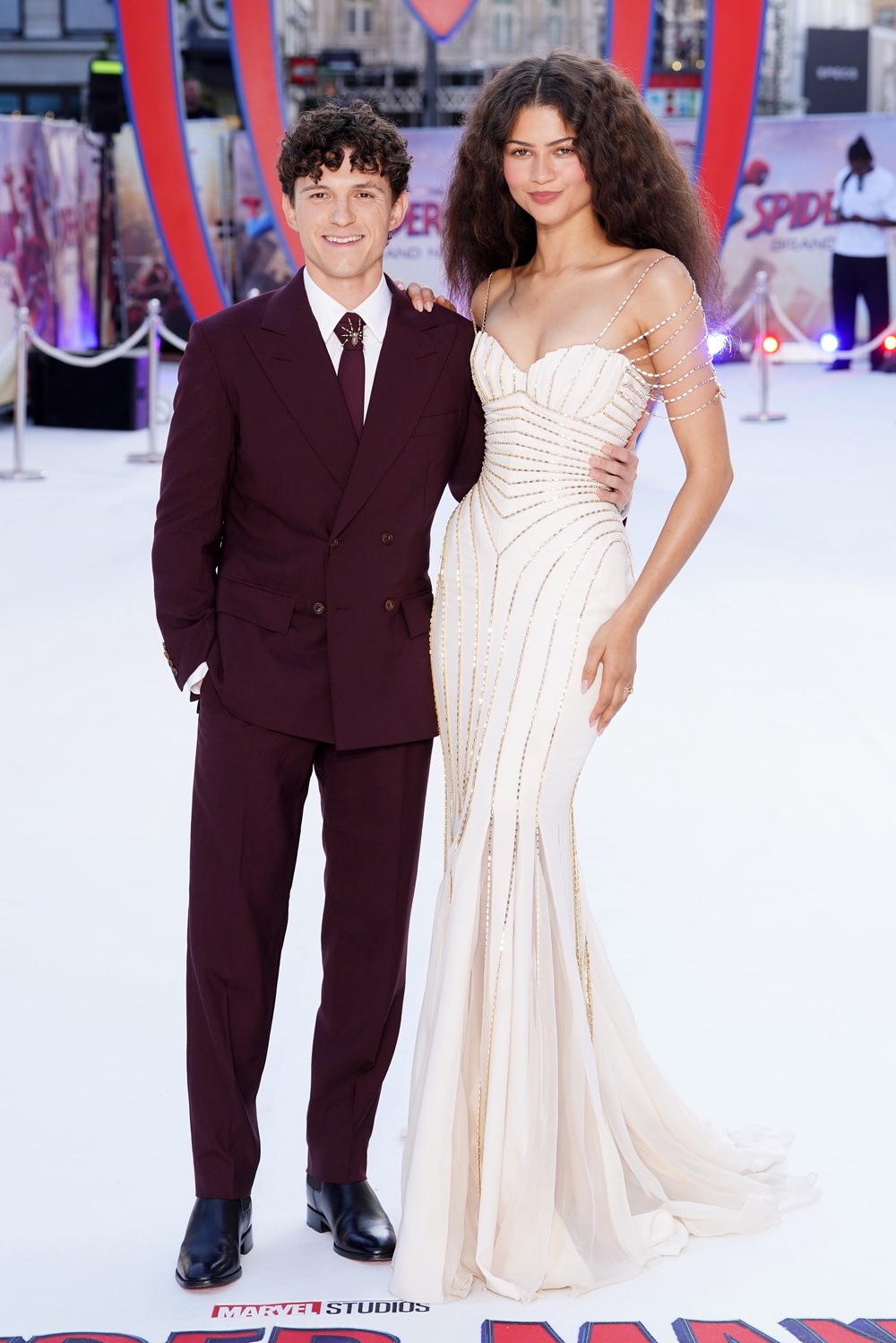 Her co-star and partner, Tom Holland, who portrays Spider-Man, complemented her look in a burgundy Louis Vuitton suit, complete with a matching tie and a striking spider brooch (Ian West/PA)