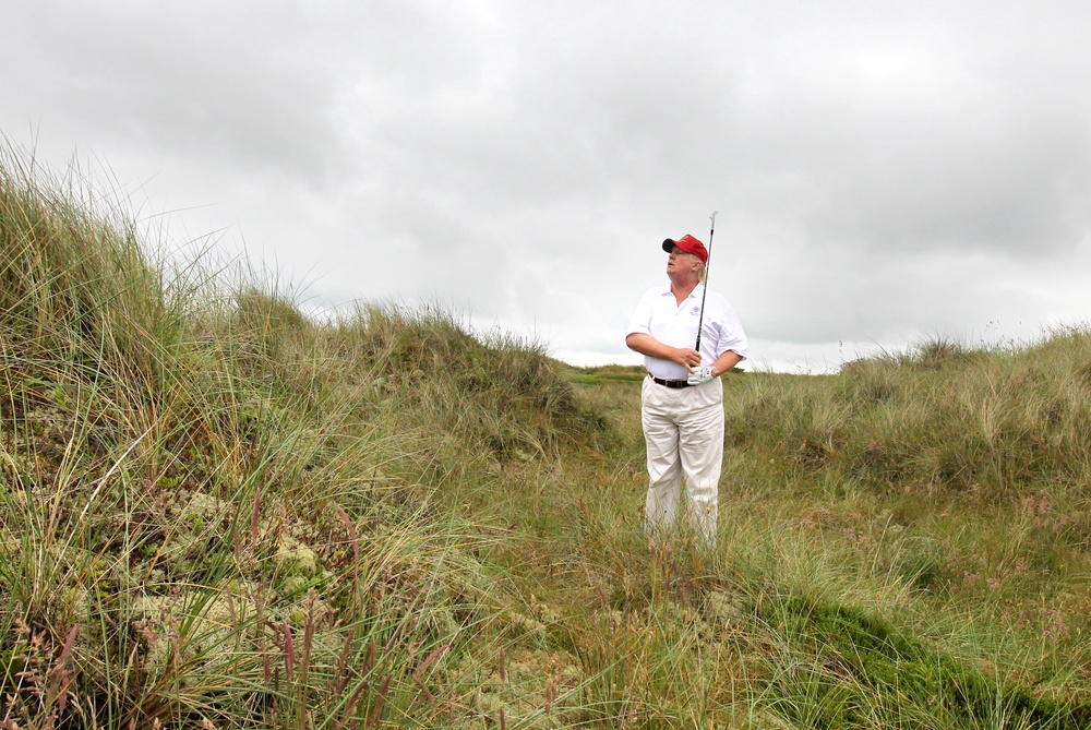 Donald Trump plays from the rough on a visit to his golf course near Aberdeen (PA) (PA Archive)