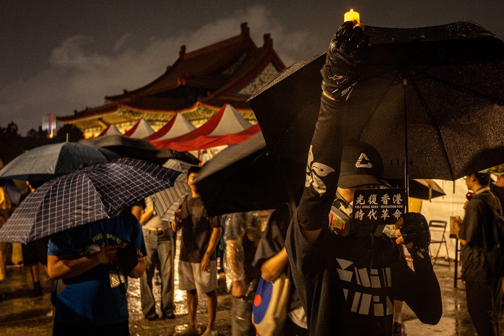 A demonstrator holds an electronic candle during a vigil at Liberty Square in Taipei on 4 June 2026, commemorating the anniversary of the 1989 Tiananmen Square Massacre in Beijing (AFP/Getty)