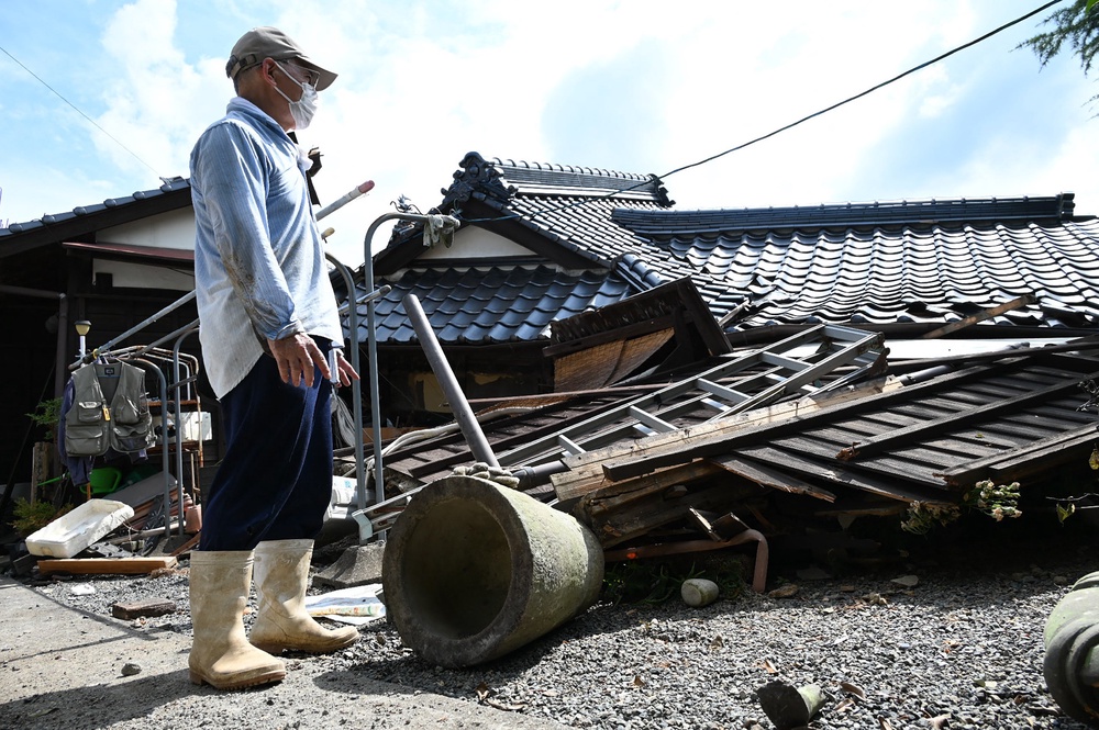 A man gazes at his collapsed home in Hikawa Town, Kumamoto Prefecture (AFP/Getty)