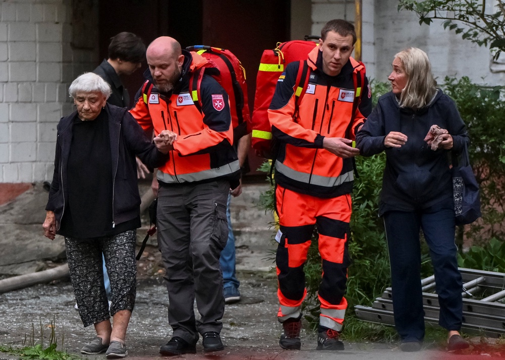 Medical workers assist residents at the site of an apartment building hit by a Russian missile strike, amid Russia's attack on Ukraine (Reuters)
