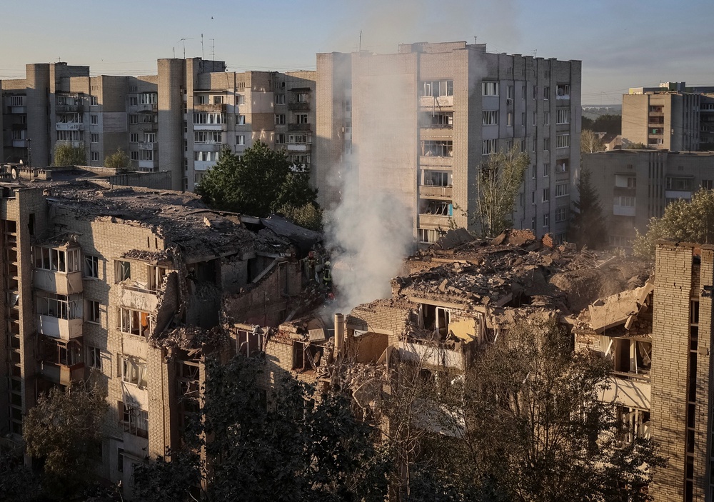 Rescuers work at the site of an apartment building hit by a Russian missile strike (Reuters)