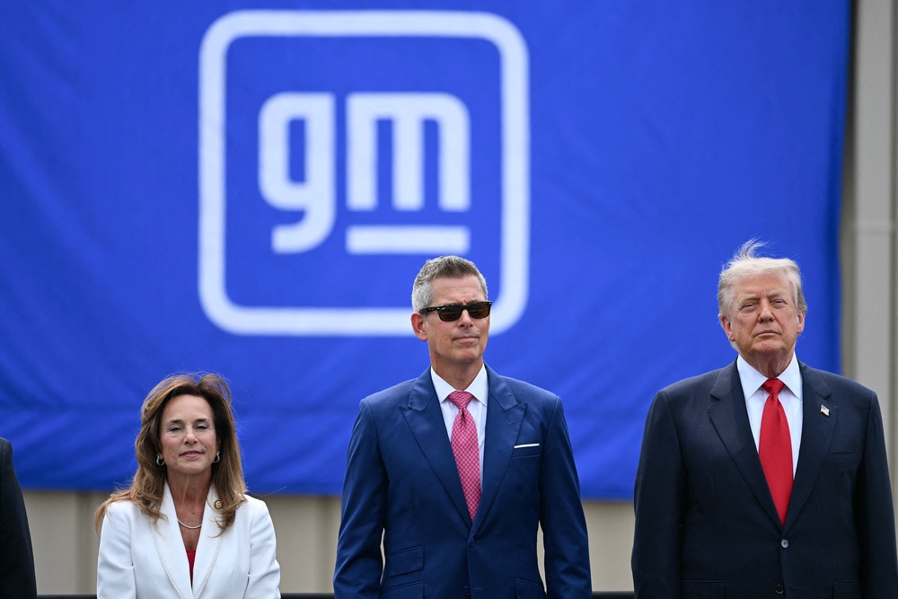 Trump is joined by, L/R, Representative Lisa McClain, Republican from Michigan and US Secretary of Transportation Sean Duffy in Michigan this week (AFP/Getty)