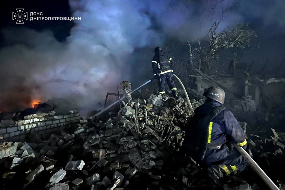 Emergency personnel at work following Russian missile strikes in Ukraine on Thursday (Reuters)