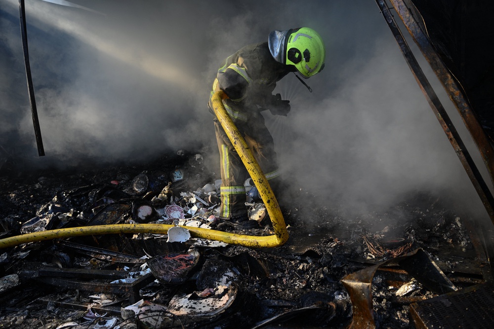 A Ukrainian firefighter works to extinguish a fire caused by the Russian attacks (AFP/Getty)