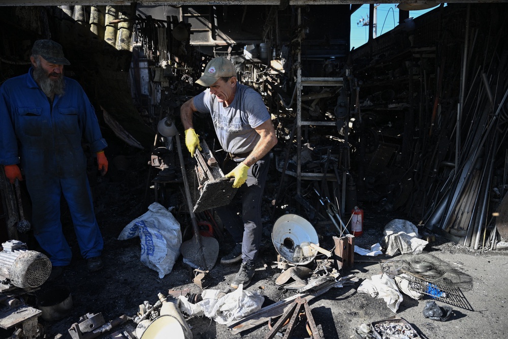 Vendors inspect their damaged stall at a market in Kyiv, Ukraine’s capital (AFP/Getty)