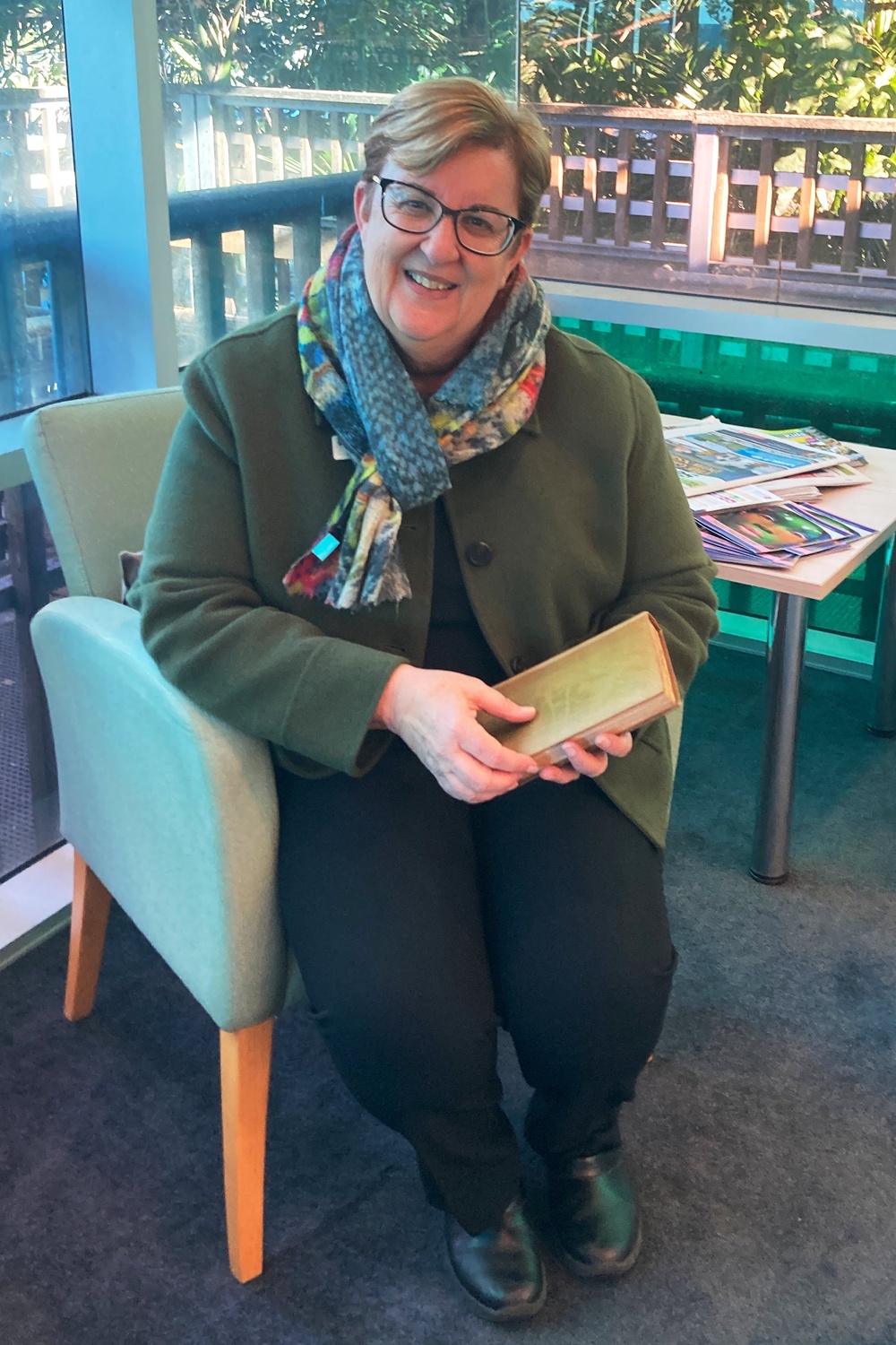 Library manager Michelle Hudson holds the book after its return (Jane Thompson via AP)