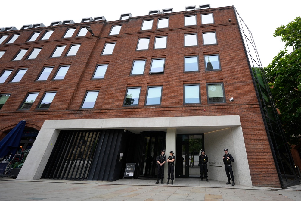 Police officers outside No 10 North, located in Heron House, central Manchester (Peter Byrne/PA Wire)