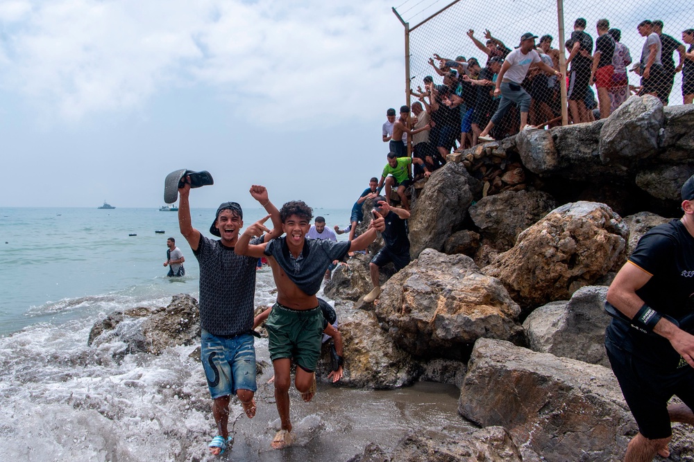 Footage showed crowds of people walking around the breakwaters at Tarajal beach (AP)